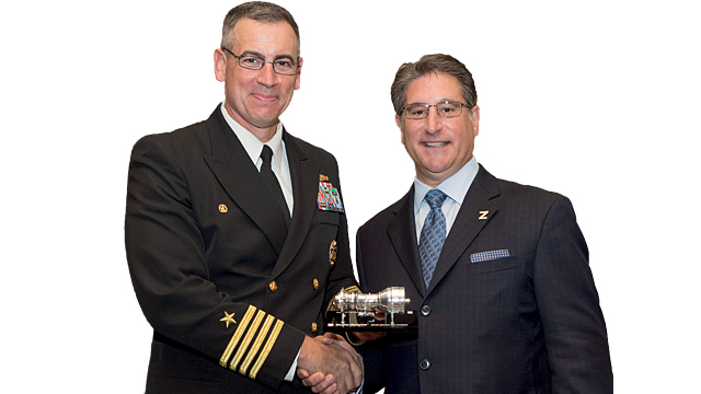 Don Roussinos, President – Naval, presents Captain James Kirk, with a scale model of the MT30
